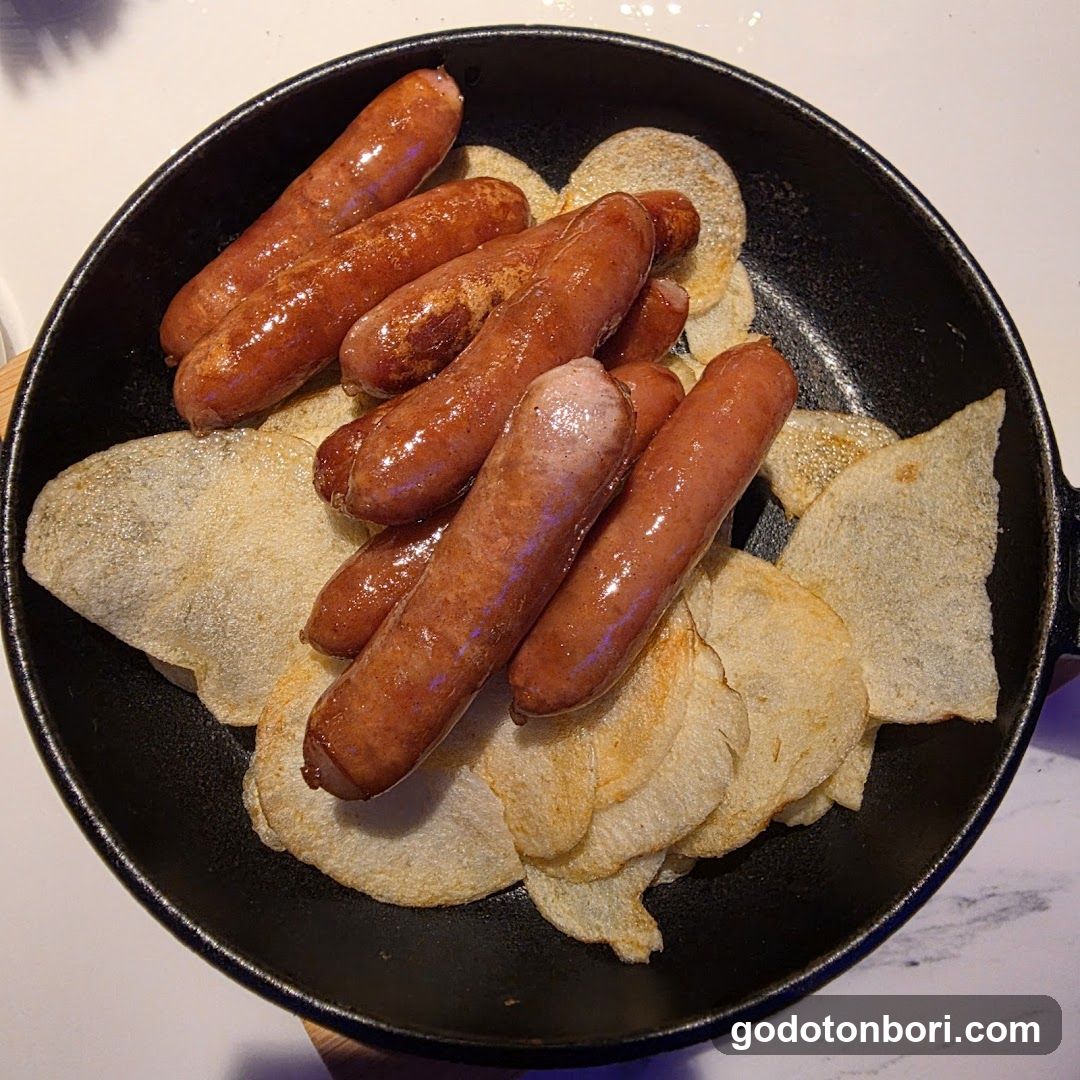 Sausages and Potato Chips in Cast Iron Skillet
