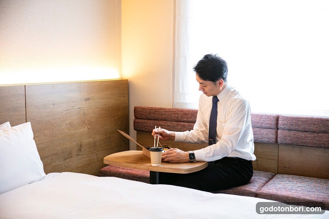 Man Working in Hotel Room