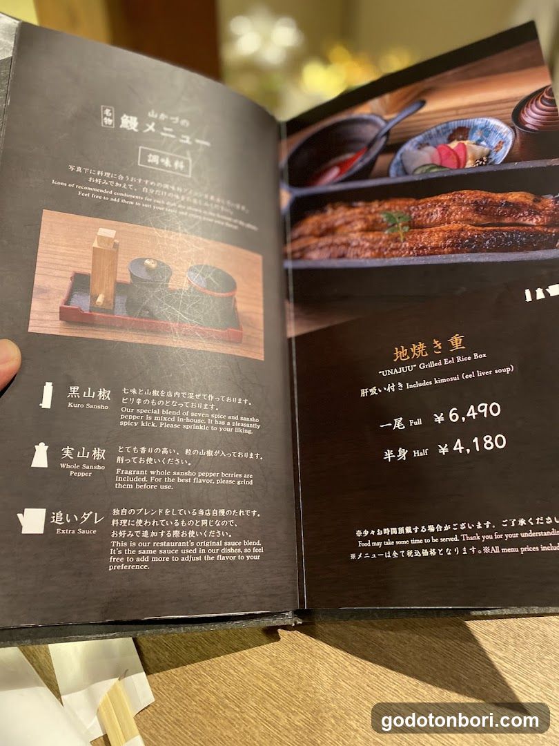 Open menu book displaying Japanese sushi items with prices and descriptions in English and Japanese.