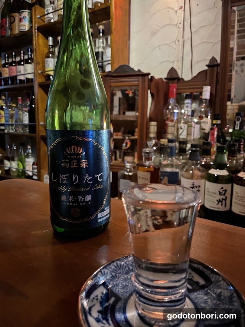 Sake Bottle and Shot Glass on Bar Counter
