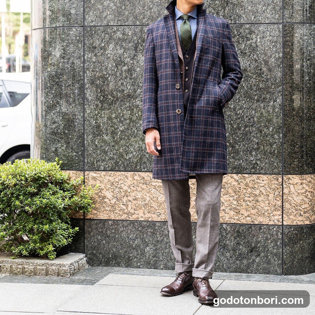 Man in Plaid Coat Standing Outside Building