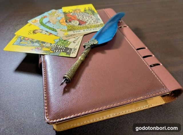 Tarot Cards and Feather Pen on Leather Journal