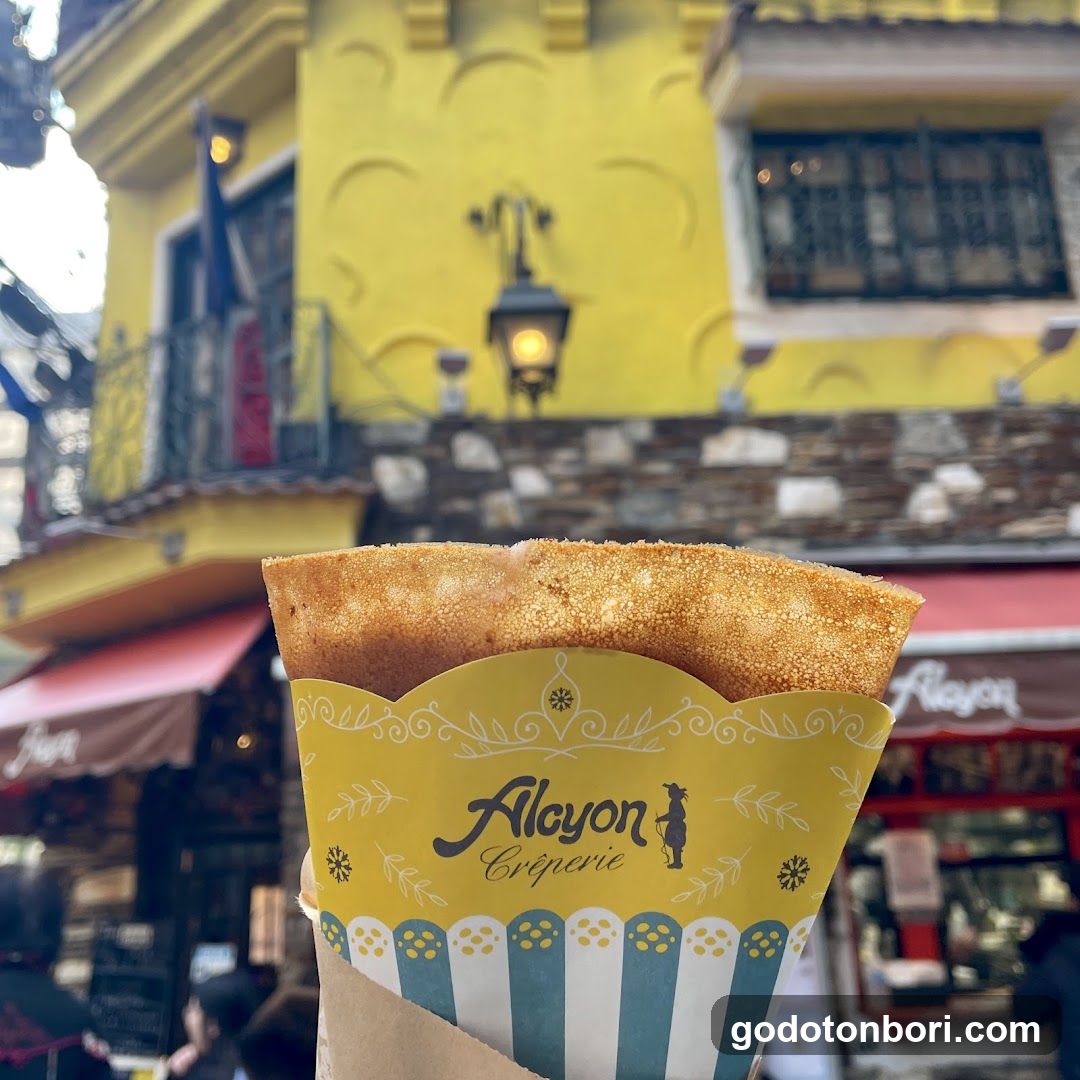 Crepe in paper cone with yellow building background