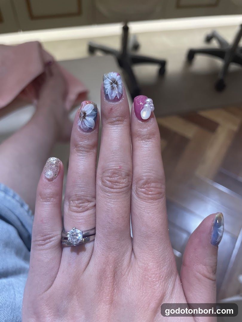 Hand with Floral Nail Art and Ring