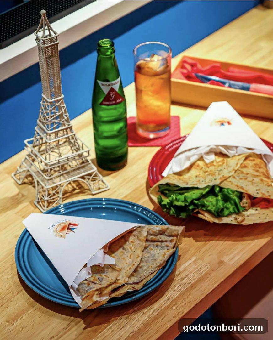 Food and Drink on Wooden Table with Eiffel Tower Model