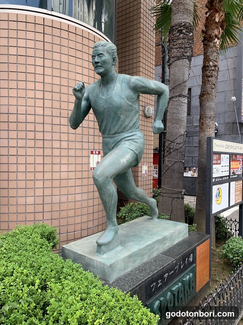 Running Statue in Urban Setting