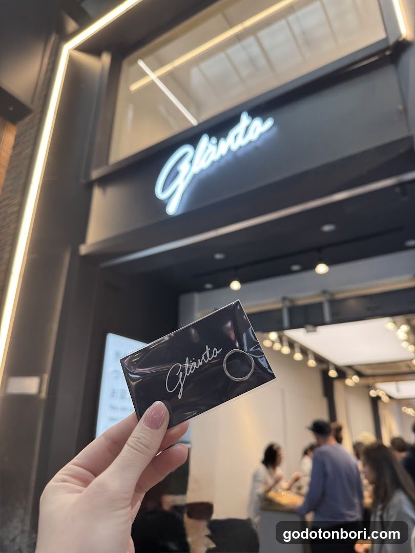 Hand holding a ring card in front of a store entrance