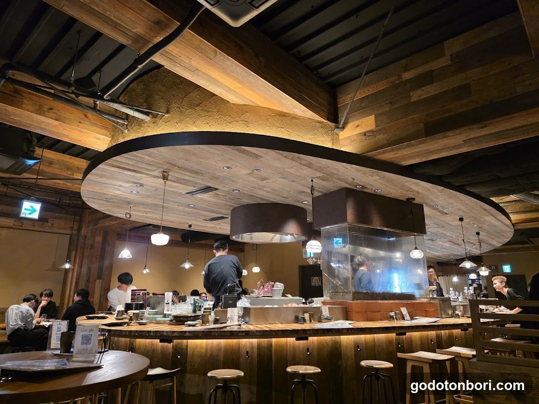 Interior of a restaurant with wooden decor and open kitchen