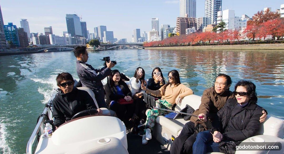 Group on a boat with city skyline in background