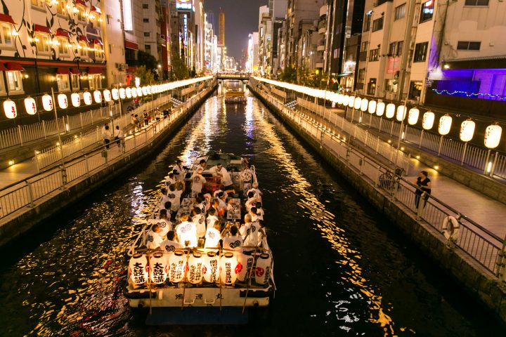 Wide view of the Dotonbori lantern festival reflecting on the canal at night
