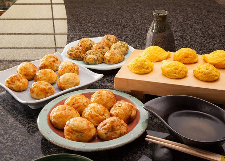 Takoyaki being grilled at Takomasa stall along Dotonbori canal in Osaka